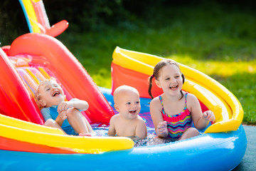 Kids playing in inflatable swimming pool