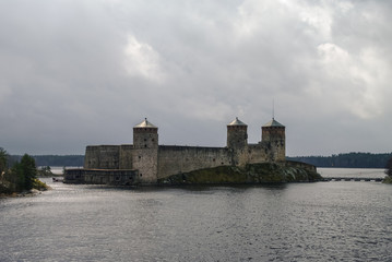 Olavinlinna fortress and Kuussalmi bay of Lake Saimaa  at rainy weather. Savonlinna, Finland.