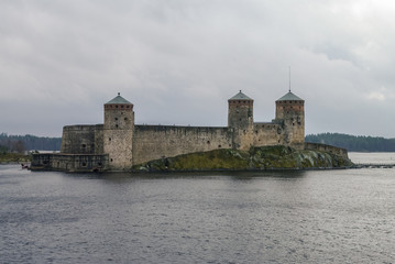 Olavinlinna fortress and Kuussalmi bay of Lake Saimaa  at rainy weather. Savonlinna, Finland.