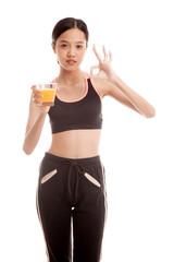 Obraz premium Beautiful Asian healthy girl drinking orange juice show OK sign isolated on white background