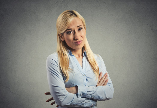 grumpy skeptical blonde woman isolated on gray background