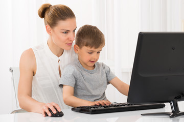 Mother And Son Using Computer