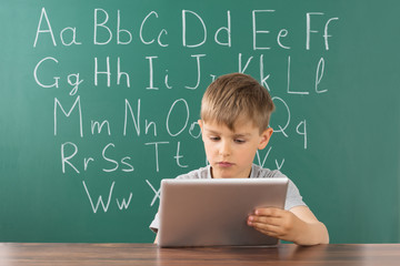Boy Using Digital Tablet At School