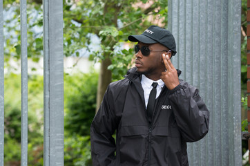 Security Guard Listening To Earpiece