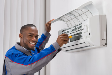 Technician Repairing Air Conditioner