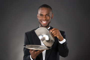 Waiter Serving Meal In Cloche - Powered by Adobe