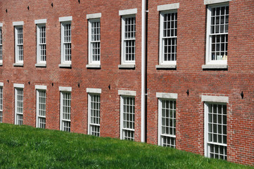 close up on old brick wall building and green lawn