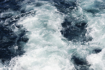 Fototapeta na wymiar water wave splash after ship propeller