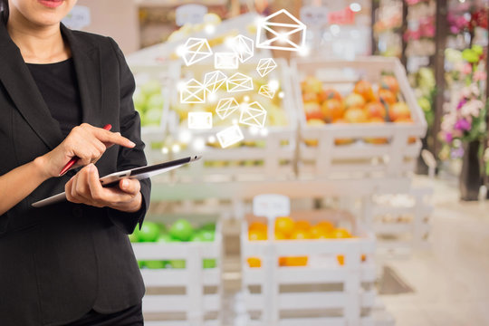 Bussiness women sending email and Shelves fruit of The Backgroun