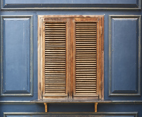 Old brown window and blue wall.