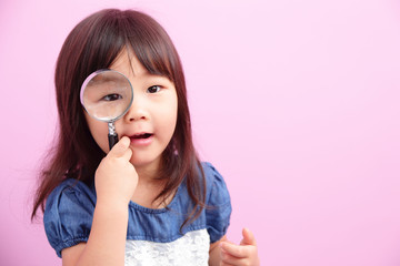 little girl holding magnifying