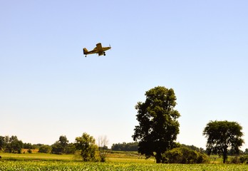 Crop dusting airplanes flying over a farmers field © in_his_image