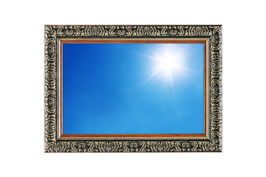 sun shines on blue sky in wooden frame isolated on white