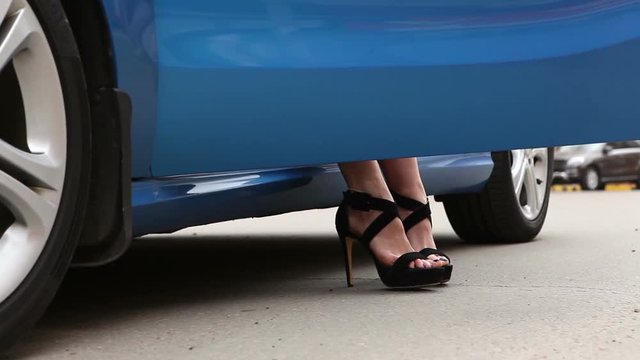 motion detail of womans legs which gets out of car