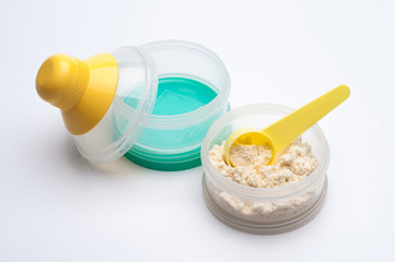 Container of powdered milk for infants on white background.