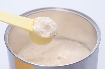 Baby milk powder in cans that open with a spoon.