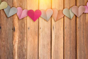 heart shape paper cut with pastel color with wood background