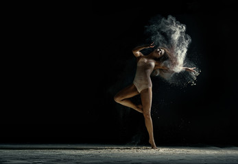 Naklejka na ściany i meble Amazing photo of graceful woman dancing with dust