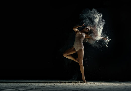 Amazing photo of graceful woman dancing with dust