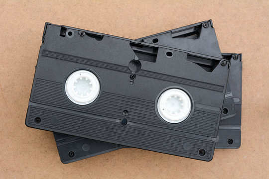 pile of videotapes on brown wooden floor background