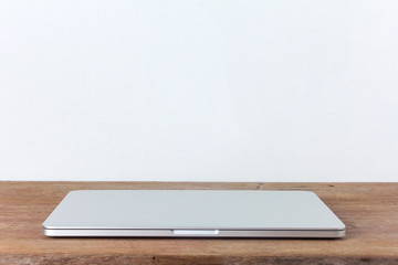 Close Laptop on wood table