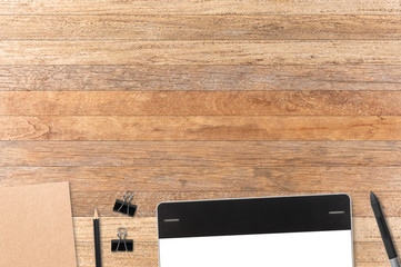 Notebook and graphic tablet on table background for text and bac