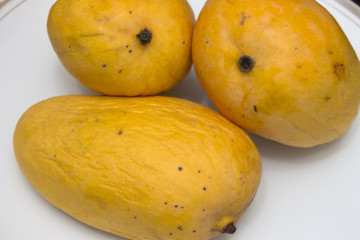 This is a photograph of Mangoes isolated on a White background