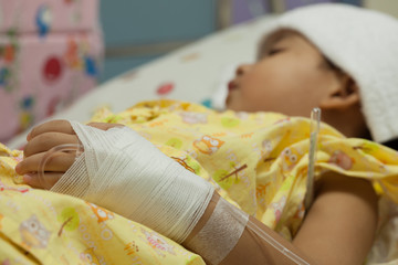  a little Boy attaching intravenous tube to patient's hand in ho
