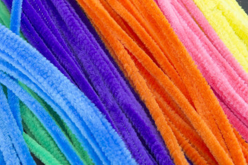 This is a photograph of Blue,Green,Purple,Orange,Pink and Yellow pipe cleaners background