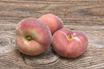 flat ripe peach on a wooden background