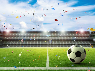 soccer ball with soccer stadium and confetti background © phonlamaiphoto