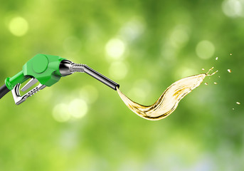green gas pump nozzle with oil splash