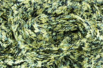 This is a photograph of Green knitting yarn background
