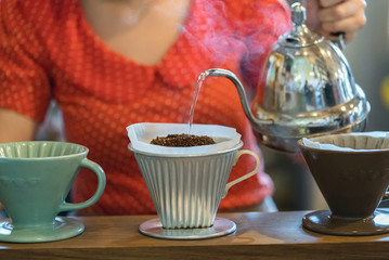 Hand drip coffee, Barista pouring water on coffee ground
