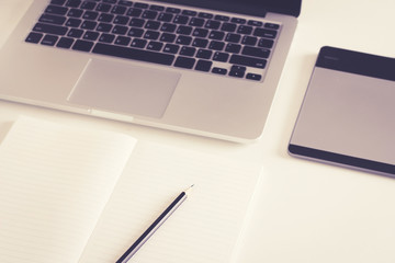 Close-up of comfortable working place with laptop, vintage effec