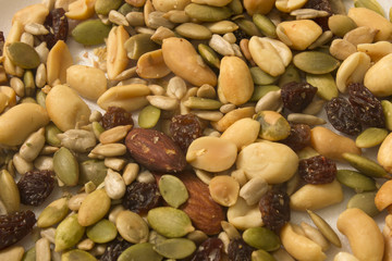 This is a photograph of seeds,peanuts,raisins and almonds