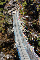 Rope bridge and prayer flags on trekking route