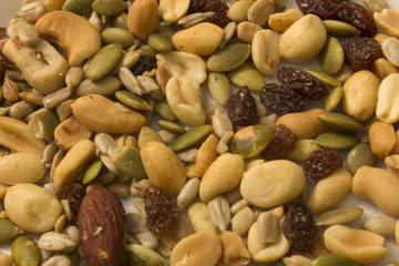 This is a photograph of seeds,peanuts,raisins and almonds