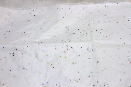 This is a photograph of White tissue wrapping paper with confetti design background