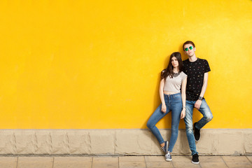 Obraz na płótnie Canvas Couple posing in fashion jeans style to the camera