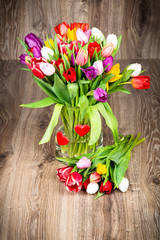Mix of tulips on wooden background