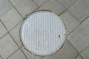 Grey metal cover of the hatch covering the technology pit