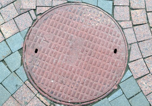Textured metal manhole cover with holes