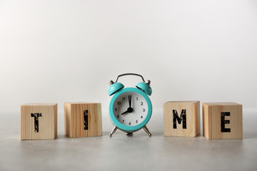 Clock and word TIME on grey background