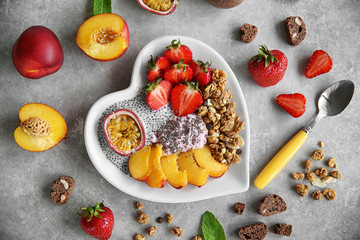 Healthy breakfast with fruits and chia seeds in heart shaped plate
