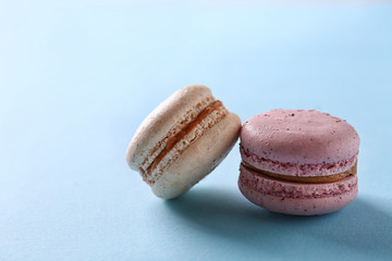 Tasty macaroons on light blue background