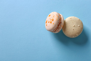 Tasty macaroons on light blue background