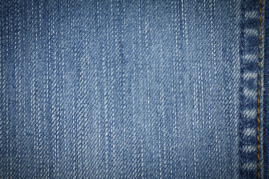 Denim jeans texture or denim jeans background with seam of fashion jeans design with copy space for text or image. Dark edged.