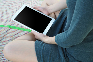 woman is hand holding blank screen tablet.