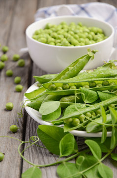 Fresh green peas on wooden background, selective focus